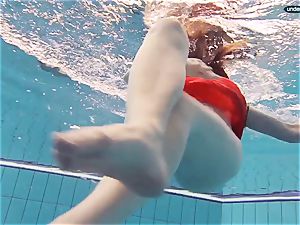 red dressed nubile swimming with her eyes opened